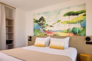 a bedroom with a bed with a painting on the wall at Best Western Arcachon Le Port in Arcachon