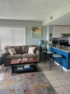 a living room with a couch and a table at Gulf Shores Plantation West #1250 in Gulf Shores