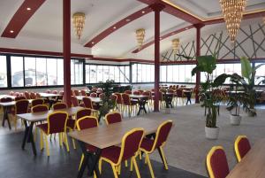 a dining room with tables and chairs and windows at Görele Liva Otel in Görele
