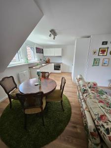 a living room with a table and chairs and a couch at Talblick Saschwalle in Sasbachwalden