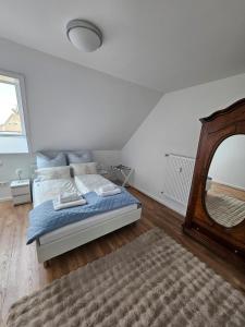 a bedroom with a bed and a large mirror at Talblick Saschwalle in Sasbachwalden