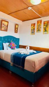 a bedroom with two beds with blue headboards at Hostal sambleño cusco Piero suite in Cusco +120 photos
