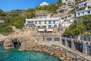 a building on a hill next to the water at Villa Lia in Massa Lubrense
