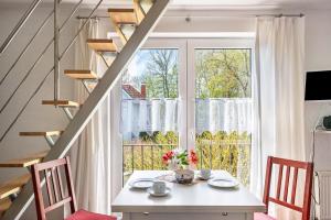 a dining room with a table and a large window at Sonne in Diedrichshagen