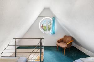 a bedroom with a bunk bed and a chair at Sonne in Diedrichshagen