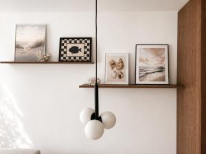a living room with a white wall with shelves at Essentia Apartament 405 in Dziwnów +38 photos