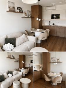 a living room with a couch and a table at Essentia Apartament 405 in Dziwnów