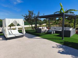 a gazebo with white couches and a tent at MAR I MONTANYA Formentera 2 in Sant Francesc Xavier