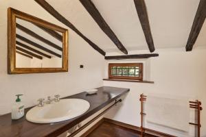 a bathroom with a sink and a mirror at La Migliana by Nicola Real Estate in Corsanico-Bargecchia +33 photos