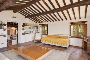 a bedroom with a bed and a table at La Migliana by Nicola Real Estate in Corsanico-Bargecchia