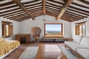 a living room with a couch and a table at La Migliana by Nicola Real Estate in Corsanico-Bargecchia