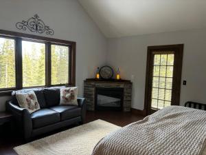 a living room with a couch and a bed at Mountain Modern 4 Bedroom Cabin on Hiking Trails in Fairplay