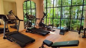 a gym with several treadmills and exercise bikes at Trobbu Boutique Collection Riviera Maya - All inclusive in Tulum