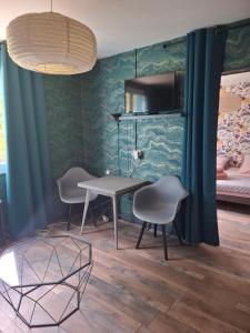 a room with a table and chairs and a bed at Chez Mikki in Cassaniouze