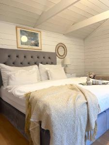 a bedroom with a large bed with white sheets at Brightside House in Kristiansand +31 photos