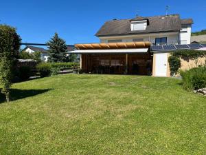 a house with a large yard with a solarium at Ferienwohnungen Forneck in Zeltingen-Rachtig +15 photos