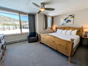 a bedroom with a bed and a chair and a window at Argentine 1516 by SummitCove Lodging in Colorado in Keystone