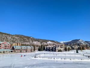 a ski resort with a lot of snow and buildings at Argentine 1516 by SummitCove Lodging in Colorado in Keystone