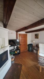a living room with a fireplace and a wooden floor at Typisches Schwedisches Haus in Eriksmåla