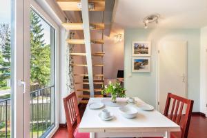 a dining room with a table and chairs and a large window at Ostsee in Diedrichshagen
