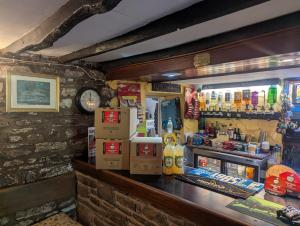 a bar in a restaurant with a counter top at Half Moon Inn in Llanthony