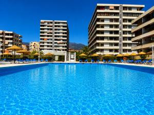 a large swimming pool in front of some buildings at Nogalera Sea View Luxe in Torremolinos