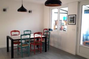 a dining room with a table and chairs at House close to the town center and the beach in Quiberon