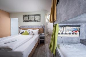 a hotel room with two beds and a window at Cubo Sport & Art Hotel in Sankt Johann in Tirol