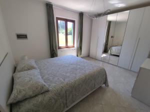 a bedroom with a bed and a large mirror at Reale Home in Casa Tonietti