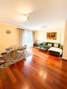 a living room with a table and a couch at Ocean Breeze in Caniço +35 photos