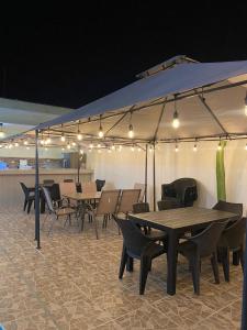 a group of tables and chairs under a tent at La Ruta in Paracas