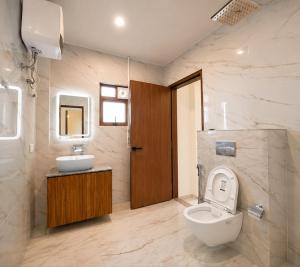 a bathroom with a toilet and a sink at Sittong Aura in Kurseong