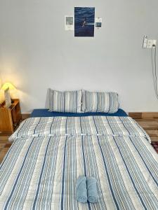 a bed with two pairs of slippers on it at Viha Homestay in Thôn Trường Giang +38 photos