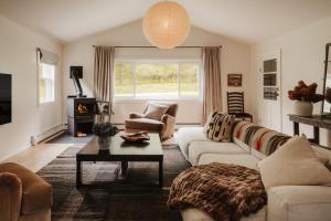 a living room with a couch and a table at Wren Cottage - Design Cabin with Secret Brook in Cochecton