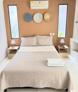 a bedroom with a large bed with two windows at Hotel TACALOA INN EXPERIENCE in Ricaurte +158 photos