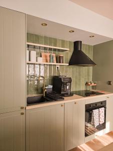a kitchen with a sink and a stove at Check in Silence in Tylicz
