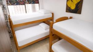 two bunk beds in a room with a window at La Gran Casa in San Andrés