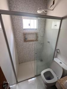 a bathroom with a shower and a toilet at Palmeira House in Formosa +9 photos