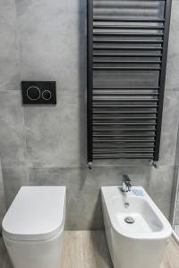 a bathroom with a white toilet and a sink at PETIT casa vacanze in Loreto +30 photos