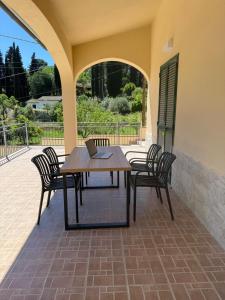 a table and chairs on a patio with a laptop on it at Reale Home in Casa Tonietti