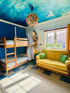 a living room with a couch and bunk beds at Captain's Log House in Baleal