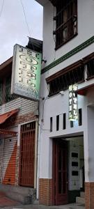 a building with a sign on the side of it at Hotel casa gustadora in Cali
