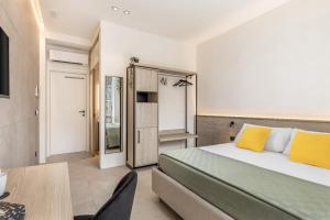 a bedroom with a bed and a desk and a table at Grafea - Luxury stay in Catania in Catania +26 photos