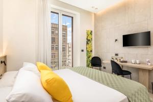a hotel room with a large bed and a desk at Grafea - Luxury stay in Catania in Catania