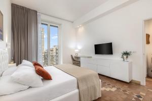 a hotel room with a bed and a tv at Grafea - Luxury stay in Catania in Catania