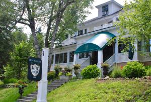 a house with a sign in front of it at The Interlaken Inn in Lake Placid