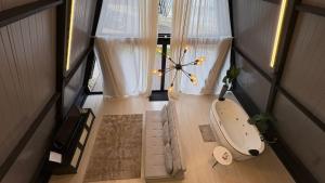 a bathroom with a tub in a room with curtains at Cabana WSA Piratuba SC in Piratuba