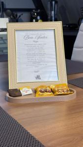 a picture frame on a table with some food at Cabana WSA Piratuba SC in Piratuba +17 photos