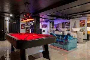 a billiard room with a red pool table at Hotel Harrison On the Beach in Miami Beach