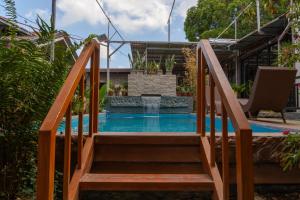 a wooden stairway leading to a pool with a fountain at La Casa Josefina in Aga